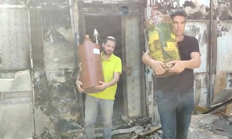 צפו: לאחר הפוגרום- ספרי תורה מוצאים מבי"כ השרוף